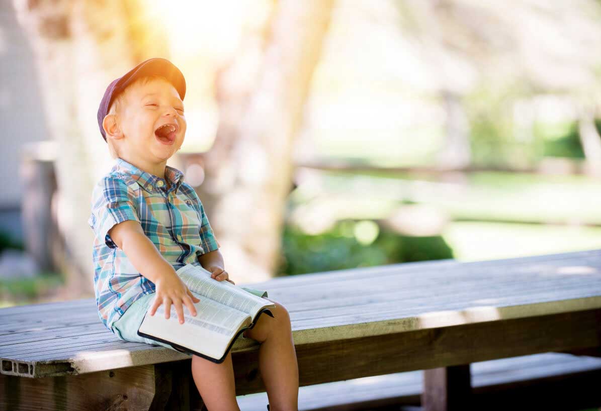 Child sitting on a park bench